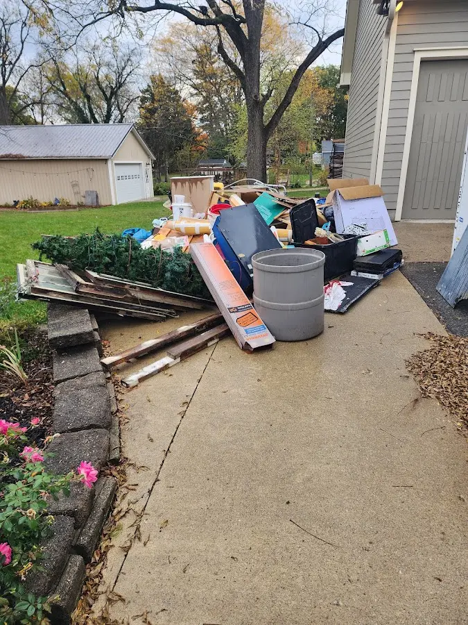 Dumpster being loaded with debris for Residential Dumpster Rental in Beachwood